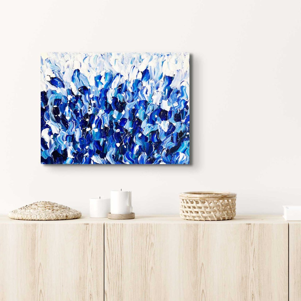 Sea of Blue, textured abstract canvas art in relaxing blues and whites seen hanging in modern setting. Original artwork by Bridget Bradley
