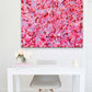 'Self Love' original painting in bright pinks, pastels and reds for Valentine's Day. seen hanging in situ above a white table. Painted by Bridget Bradley to celebrate 'self love'