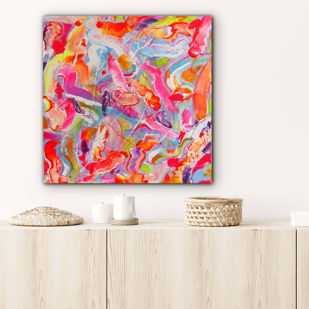 Sugar Fix hand painted abstract on canvas seen hanging in situ above wooden console. Brightly colored in pinks oranges, yellows, blues. Textured abstract by Bridget Bradley