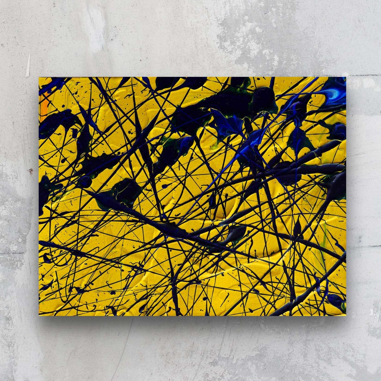 Yellow, Original abstract painting on paper in rich yellows and blues. Seen hanging on stone wall, painted by Bridget Bradley